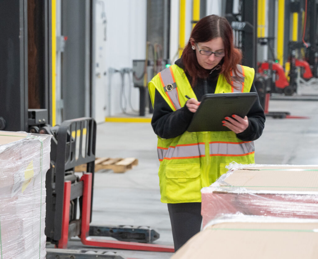 Female worker on the dock at Arcadia Cold facility handling inbound shipments with precision and care.